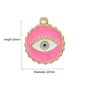 Golden evil eye charm with pink and blue enamel detailing, measuring 24mm by 22mm