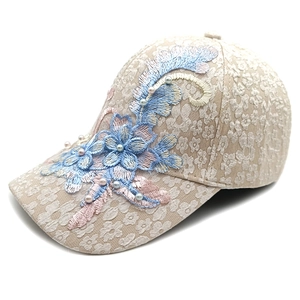 Detail of floral lace baseball cap with 3D flower embroidery and white pearls