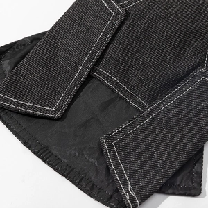 Detailed view of dark denim pet dress featuring white double stitching and split hem design