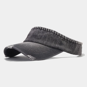Detail view of frayed edges on a vintage dark grey washed denim sun visor hat