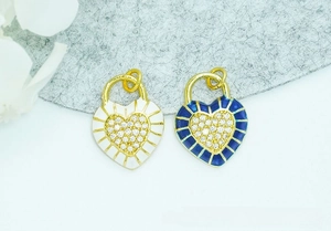 Detail of white and blue heart pendants with 18K gold plating and micro-pave crystals
