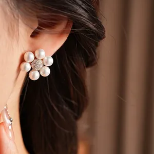 Elegant French vintage floral pearl earrings with zircon inlay shown on model