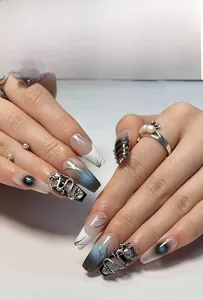 Detailed view of 3D silver dragon relief and blue gradient marble on long coffin nails