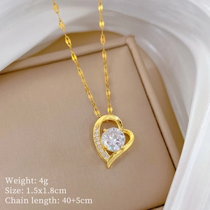 Detail of gold heart necklace with embedded crystals and product size specifications