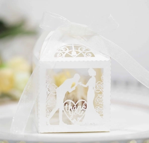 Detailed laser-cut white wedding favor box with romantic silhouette and thank you text