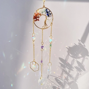 Macro shot of tree of life suncatcher with crystals casting colorful rainbow light