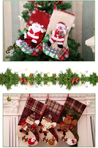 Detail of large plaid Christmas stockings with Santa and reindeer embroidery on fireplace