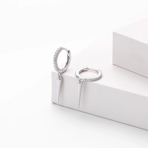 Macro detail of S925 sterling silver hoop earrings with clear zircons and sharp spikes