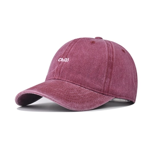 Detailed side view of washed burgundy cotton baseball cap with white Chili embroidery