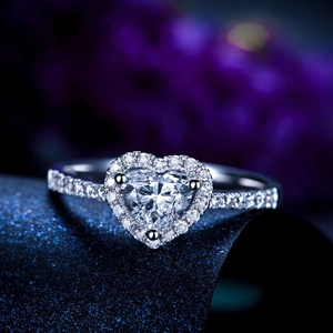 Detailed macro view of a sparkling heart-shaped diamond halo ring with pavé stones on band