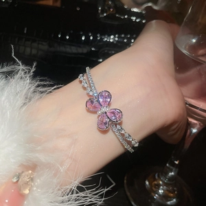 Detailed macro of a double-layer butterfly bracelet with pink zircons and pearls
