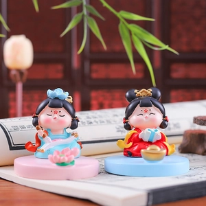 Detailed view of Q-style ancient Chinese figurines with books and gold ingots decor