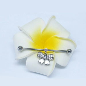 Silver industrial piercing bar with butterfly pendant and pink crystal on Frangipani