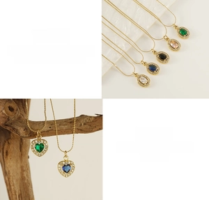 Detailed macro view of gold plated titanium necklace with colorful zircon heart pendants