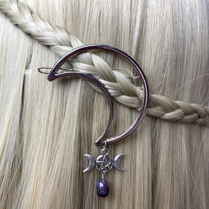 Moon shaped hair clip with silver stars and purple crystal pendant on blonde hair