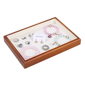 Solid wood jewelry display tray with beige lining for rings and bracelets