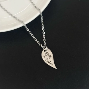 Big Sister heart puzzle necklace in silver finish with engraved stars and heart details