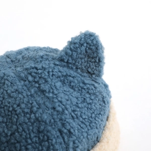 Detail of baby winter hat featuring cute navy blue fleece ears and soft texture