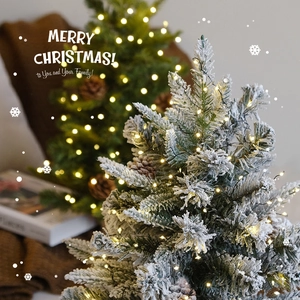 Mini artificial Christmas trees with warm LED lights and pine cones for table decor