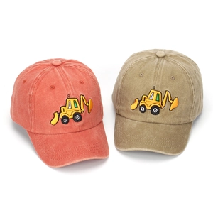 Detail of orange and khaki washed cotton baseball caps with excavator embroidery