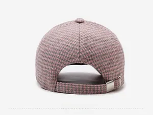 Detail view of pink plaid wool baseball cap with adjustable silver metal buckle at the back