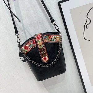 Chinese style black bucket bag with colorful floral embroidery and metal chain strap