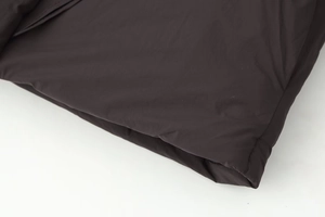 Detailed close-up of dark brown matte polyester fabric texture and fine hem stitching