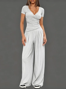 Women's grey two-piece lounge set with short sleeve V-neck top and wide-leg trousers
