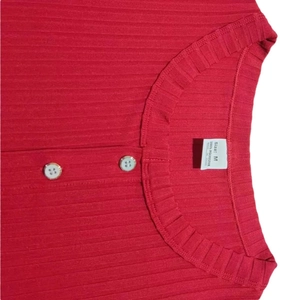 Detail view of red ribbed Henley T-shirt neckline with buttons and size M inner label