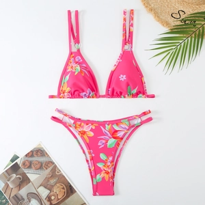 Close-up of tropical floral pink bikini with gold rings and double strap details