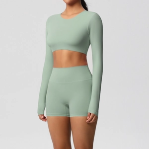 Close-up of sage green yoga set with long sleeve crop top and high waist gym shorts