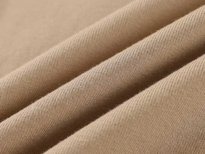 Macro shot of khaki cotton fabric showing professional twill weave texture and softness