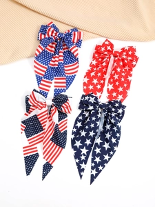 Close-up of patriotic American flag bow hair clips with stars and stripes fabric patterns