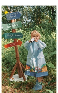 Waterproof blue children rain coat with forest animal prints and yellow buttons in nature