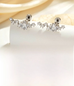 Macro view of silver star cartilage earring with sparkling zircon and steel screw back
