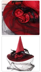 Detail of red silk witch hat featuring black feathers, roses and mesh veil for party