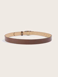 Detail of a brown leather belt with silver heart buckle and eyelets on beige background