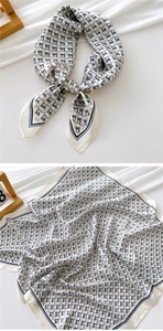 Detailed pattern of small square silk scarf with geometric horse head print on satin fabric