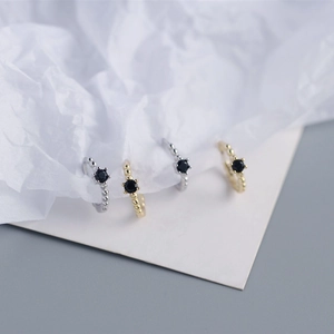 Detail of S925 sterling silver hoop earrings with black zircon and beaded texture edges