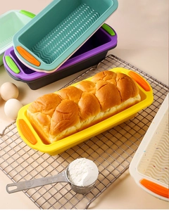 Detail view of colorful silicone loaf pans with non-slip handles and wavy bottom texture