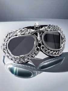 Macro detail of gothic steampunk goggles with metal chain frame and silver skull emblem