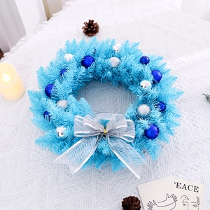 Sky blue Christmas wreath with silver bows and ornaments on a lace tablecloth