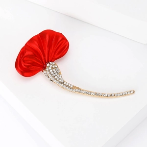 Elegant ginkgo leaf brooch with red enamel petals and gold rhinestones on white base