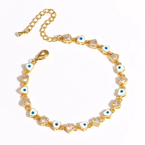 Close-up of gold heart evil eye bracelet with blue enamel and sparkling zircon stones