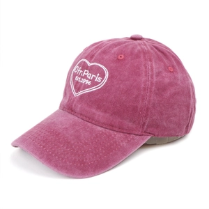 Detail of a magenta washed cotton baseball cap with white embroidered Ofr.Paris heart logo