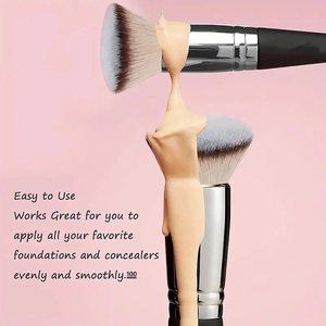 Close-up of foundation application on a dual-ended makeup brush with soft bristles