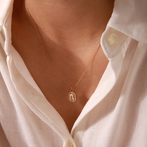 18K gold plated stainless steel necklace with rectangular crystal pendant on model