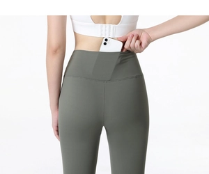 Detail of high-waisted yoga pants showing hidden back pocket with a mobile phone