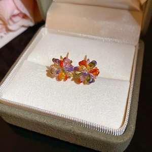 Close-up of colorful crystal flower earrings in a premium velvet jewelry gift box