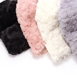Detailed texture of thick plush faux fur bucket hats in black, pink, beige, and grey colors